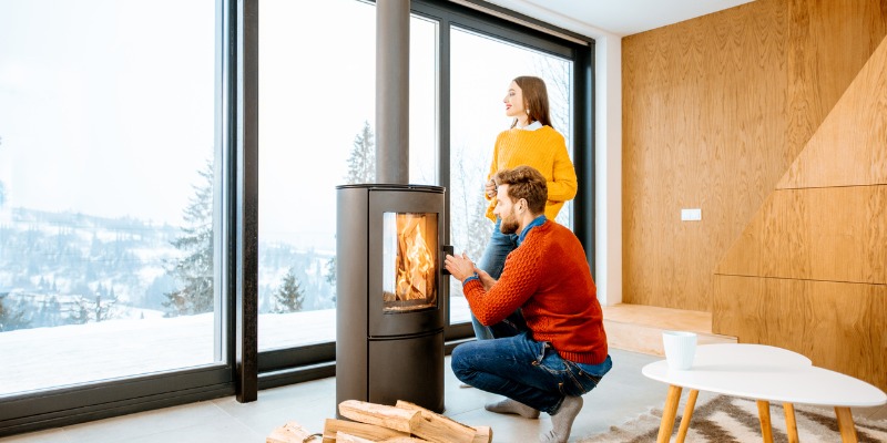 couple standing in front of fireplace