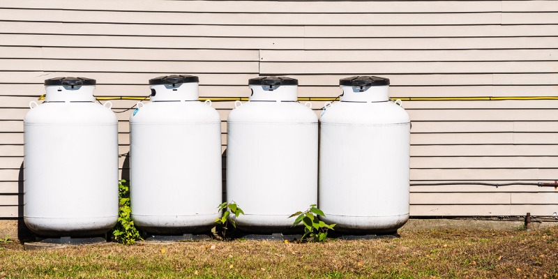 image of 4 propane tanks lined up against a house