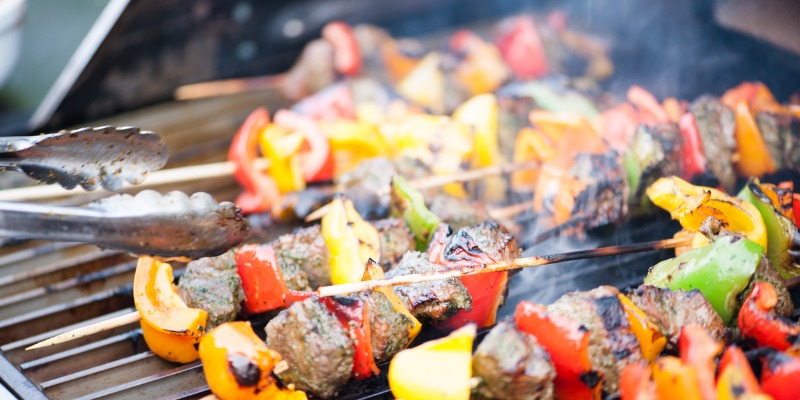 Skewers on the BBQ with a lot of smoke - How to Turn Your BBQ into a Home Smoker